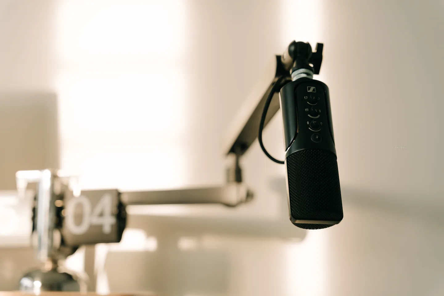 Close-up of a studio microphone on a boom arm.